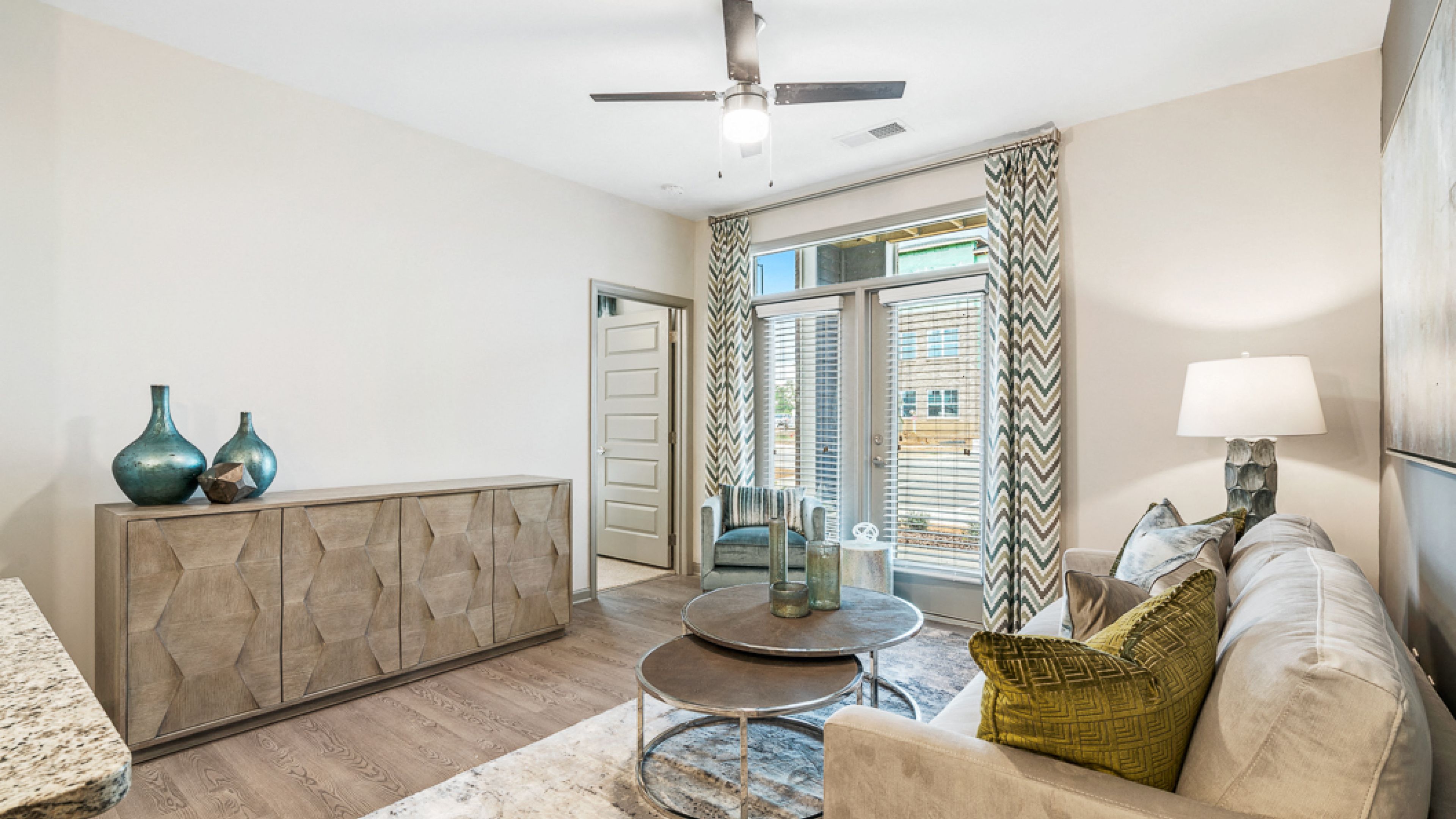 Hawthorne at The GlenModern apartment living room with large balcony doors